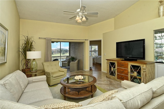 living room featuring light tile patterned flooring, a textured ceiling, and ceiling fan