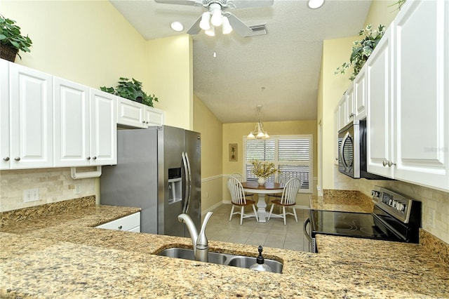 kitchen featuring sink, backsplash, stainless steel appliances, and white cabinets