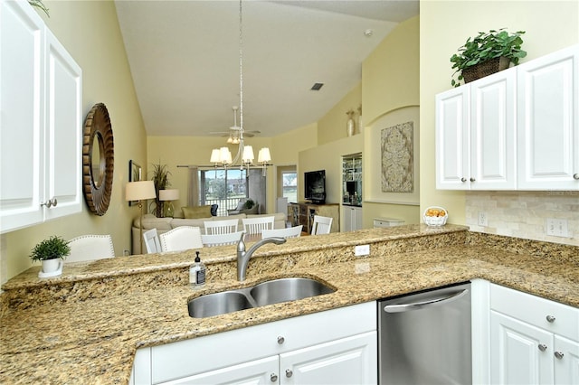 kitchen featuring dishwasher, lofted ceiling, sink, and white cabinets