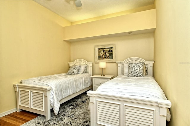 bedroom with dark wood-type flooring and ceiling fan