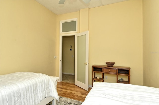 bedroom with wood-type flooring and ceiling fan