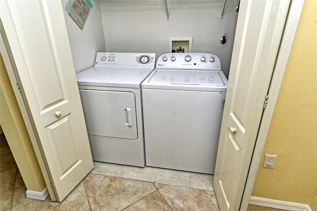 clothes washing area with washing machine and dryer