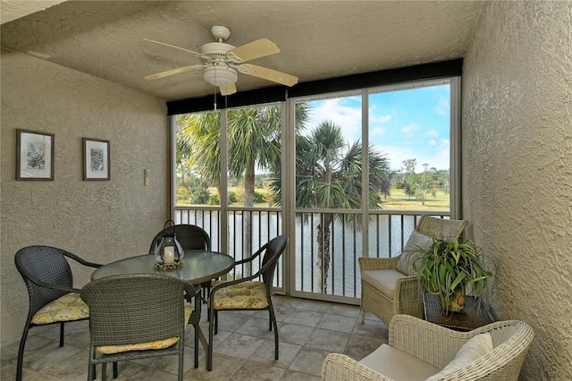 sunroom / solarium featuring plenty of natural light and ceiling fan