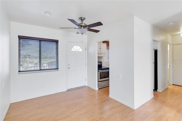 entrance foyer with ceiling fan and light hardwood / wood-style floors