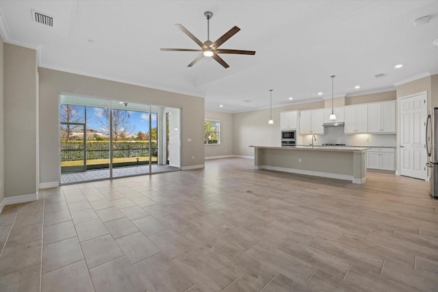 unfurnished living room featuring crown molding, ceiling fan, sink, and light wood-type flooring