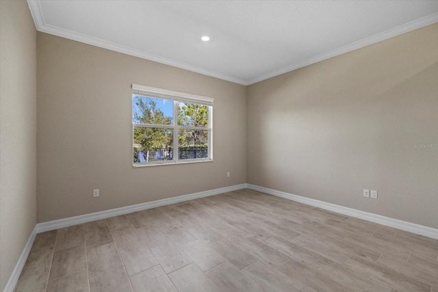 spare room featuring crown molding and light hardwood / wood-style floors