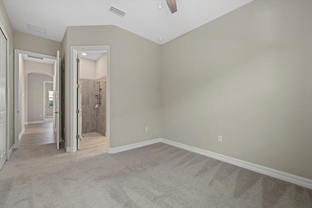 unfurnished bedroom featuring ceiling fan, connected bathroom, and light carpet