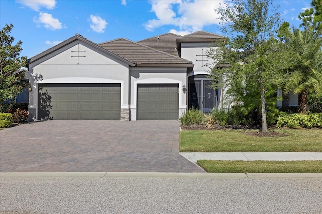 view of front of house with a garage and a front yard