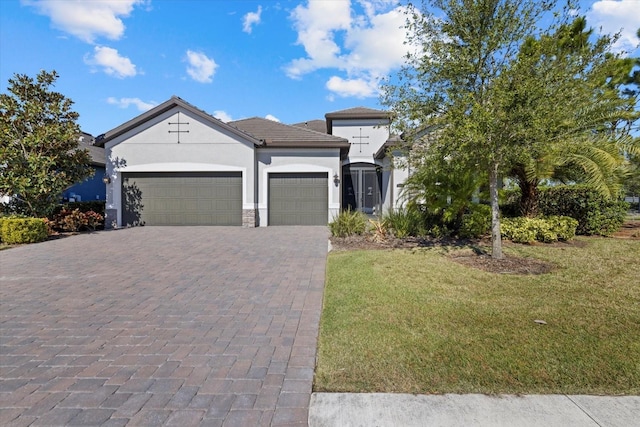 view of front of property featuring a garage and a front yard