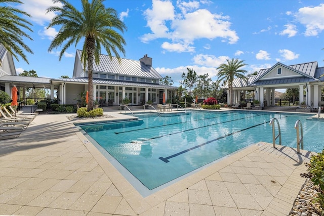 view of swimming pool featuring a patio and a gazebo