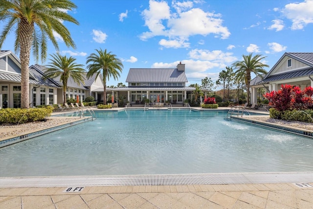 view of swimming pool with pool water feature