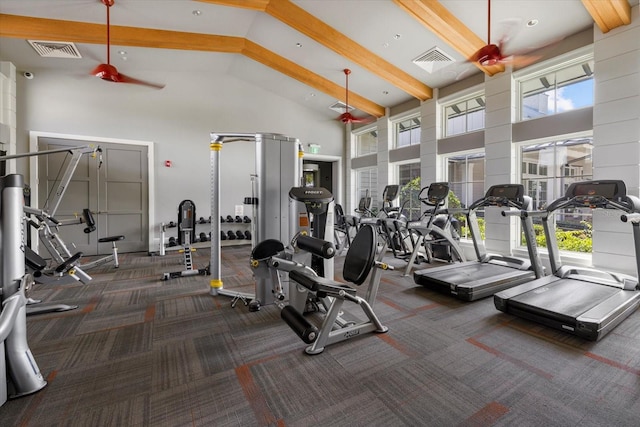 exercise room with dark colored carpet and high vaulted ceiling