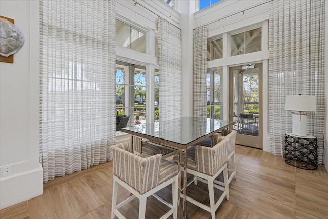 dining space featuring french doors and a high ceiling