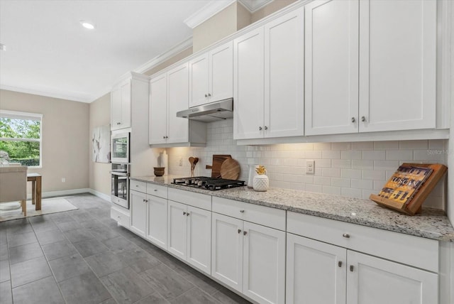 12029 Perennial Pl, Lakewood Ranch, FL 34211 - kitchen with appliances with stainless steel finishes, under cabinet range hood, baseboards, white cabinets, and backsplash
