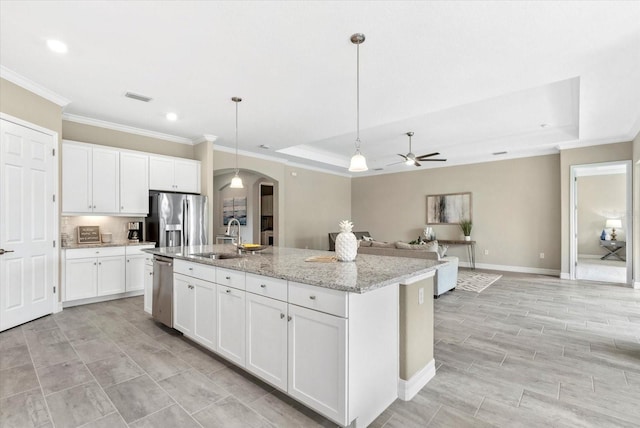 12029 Perennial Pl, Lakewood Ranch, FL 34211 - kitchen featuring stainless steel appliances, a sink, arched walkways, ornamental molding, and ceiling fan