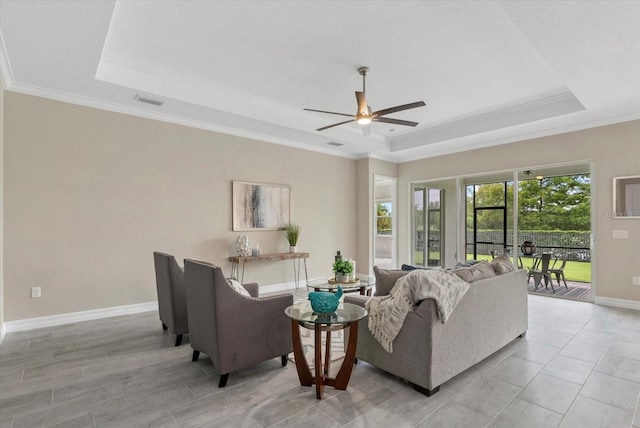 12029 Perennial Pl, Lakewood Ranch, FL 34211 - living area with a tray ceiling, crown molding, a ceiling fan, and baseboards