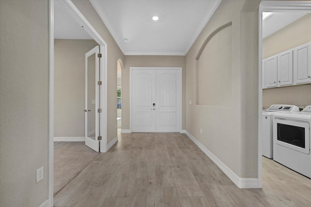 12029 Perennial Pl, Lakewood Ranch, FL 34211 - hallway featuring arched walkways, washer and clothes dryer, baseboards, and crown molding
