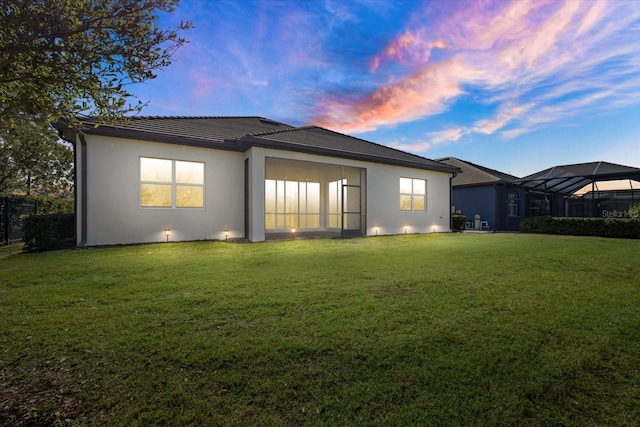 12029 Perennial Pl, Lakewood Ranch, FL 34211 - back of property featuring a yard and stucco siding