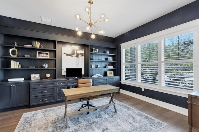 home office with an inviting chandelier, visible vents, baseboards, and dark wood-style flooring