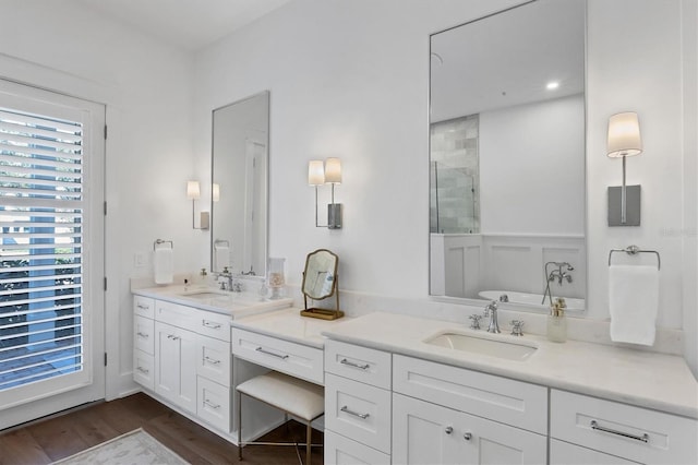 full bathroom featuring a freestanding tub, a stall shower, wood finished floors, and vanity