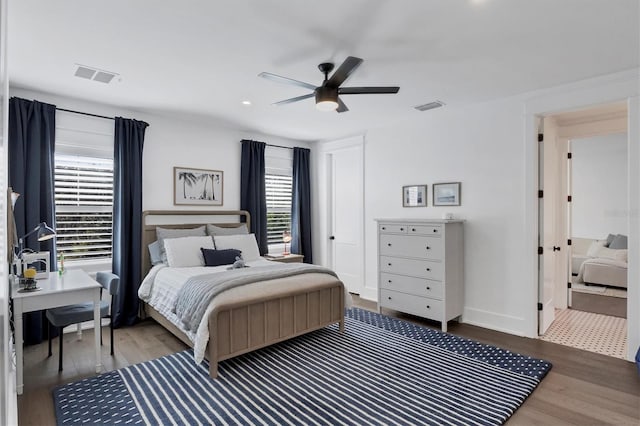 bedroom featuring visible vents, baseboards, and wood finished floors