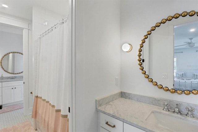 ensuite bathroom with tile patterned floors, a shower with curtain, ensuite bathroom, and vanity