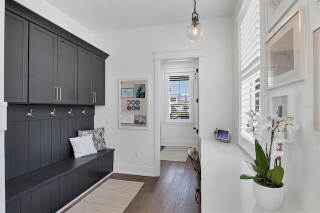 mudroom with dark wood-type flooring and baseboards