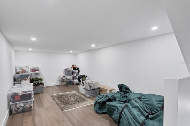 interior space featuring baseboards, wood finished floors, and recessed lighting