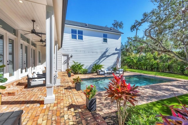 outdoor pool featuring a ceiling fan and a patio