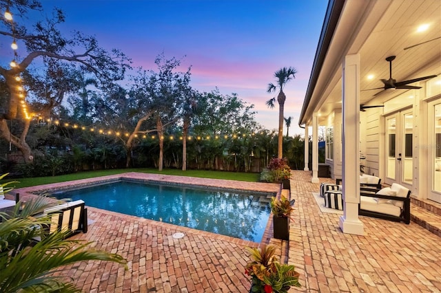 view of pool featuring a fenced in pool, a patio area, and ceiling fan