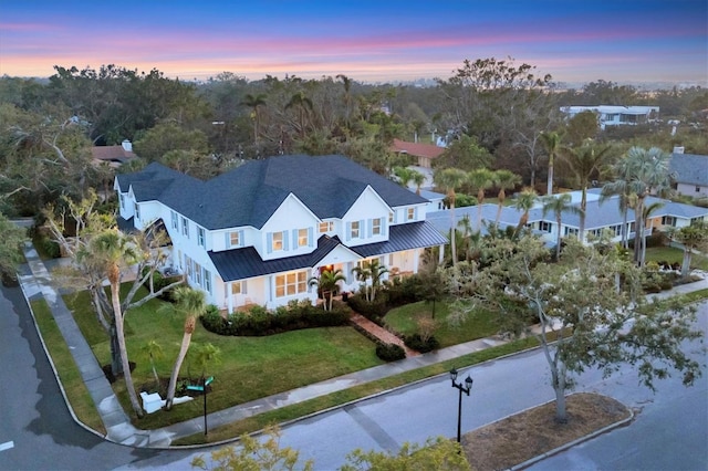 aerial view at dusk featuring a residential view