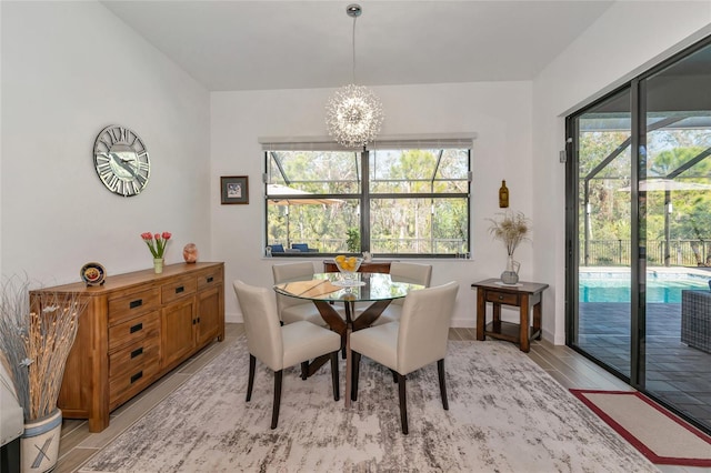 dining space featuring an inviting chandelier, light hardwood / wood-style floors, and a wealth of natural light