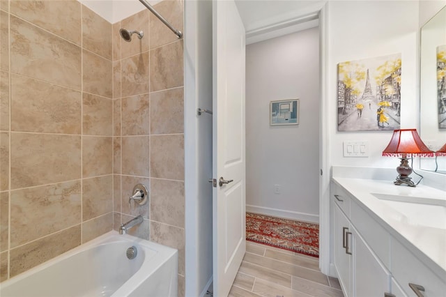 bathroom featuring vanity and tiled shower / bath combo