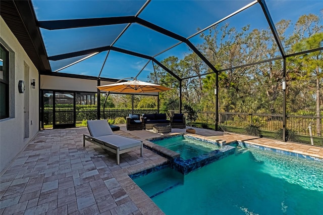 view of swimming pool featuring an in ground hot tub, a patio, outdoor lounge area, and glass enclosure