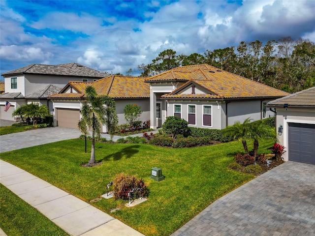 view of front of home with a garage and a front lawn