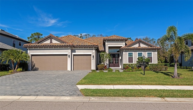 mediterranean / spanish-style house featuring a garage and a front yard