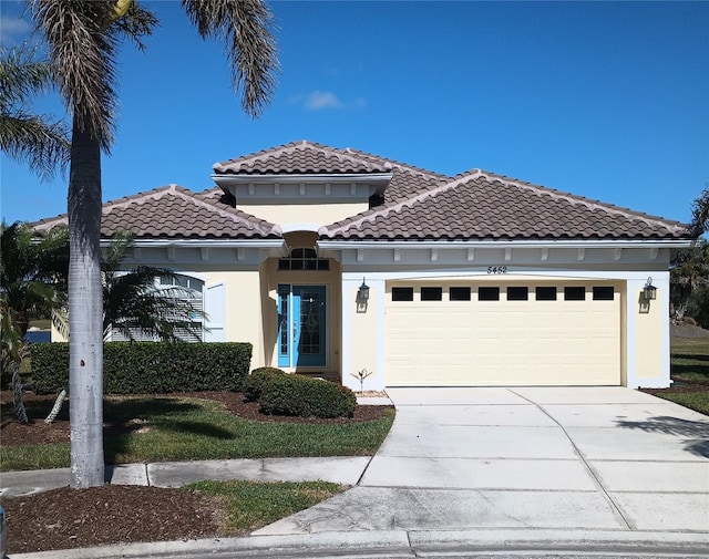 mediterranean / spanish home with a garage