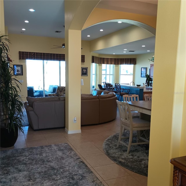 tiled living room with ceiling fan