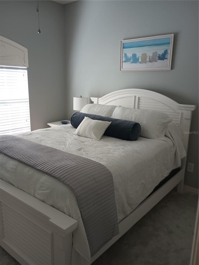 bedroom featuring dark colored carpet