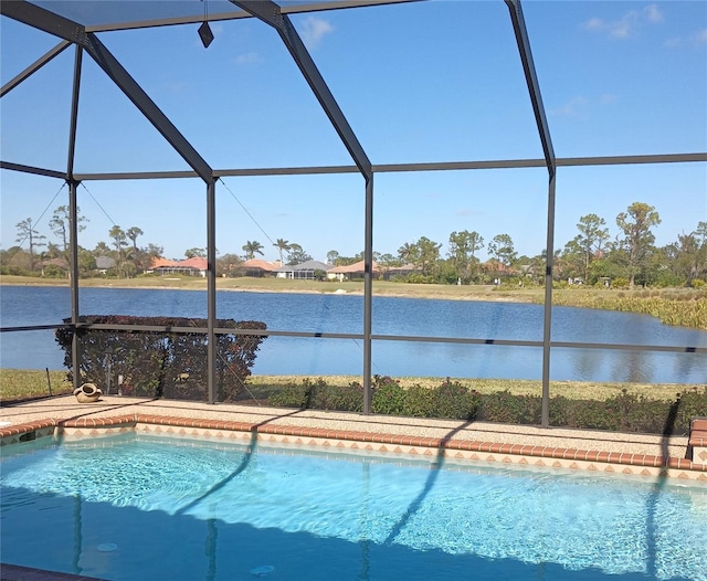 view of swimming pool with a water view and glass enclosure