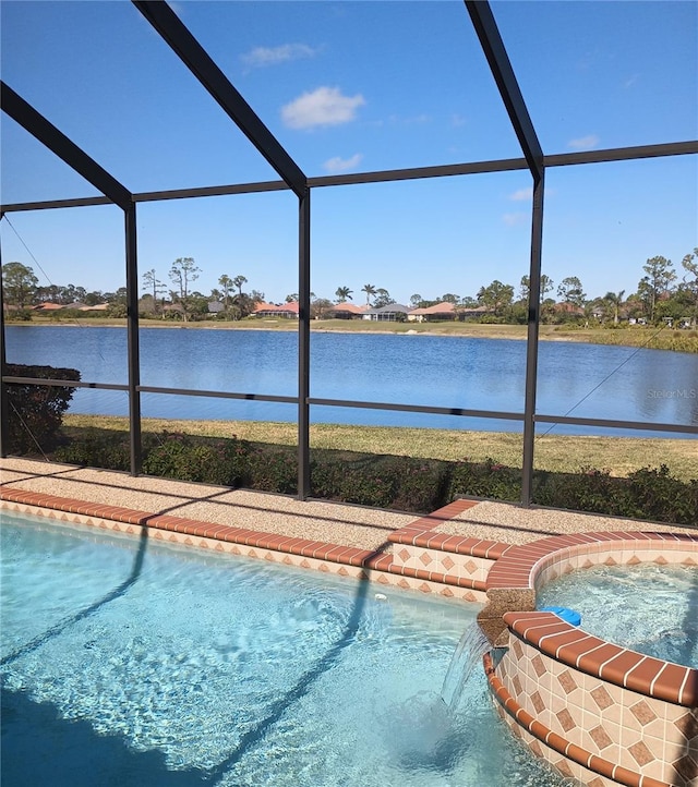 view of swimming pool with an in ground hot tub, a water view, and glass enclosure