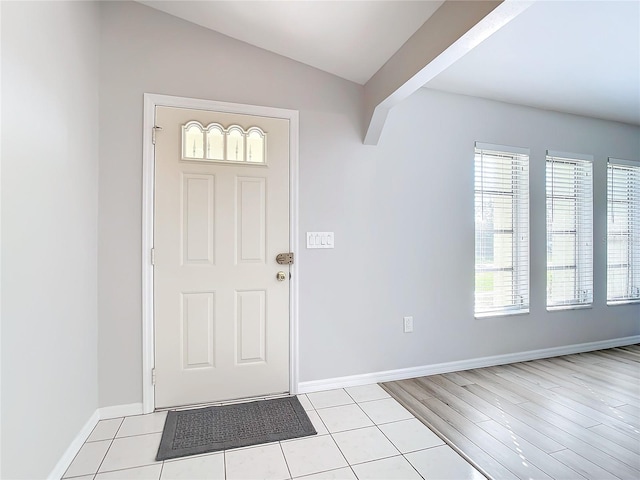 tiled foyer entrance with lofted ceiling