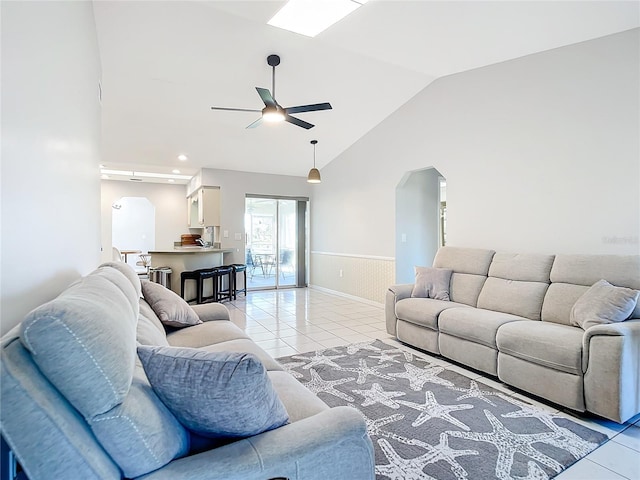 tiled living room featuring high vaulted ceiling and ceiling fan