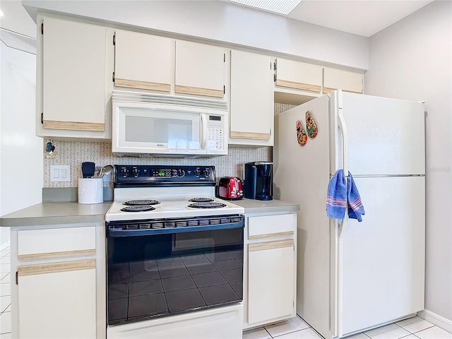 kitchen featuring backsplash, white appliances, and white cabinets