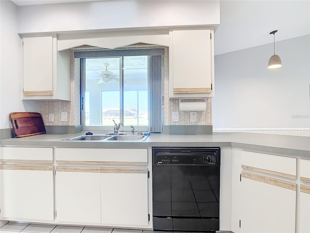 kitchen featuring sink, hanging light fixtures, black dishwasher, white cabinets, and decorative backsplash