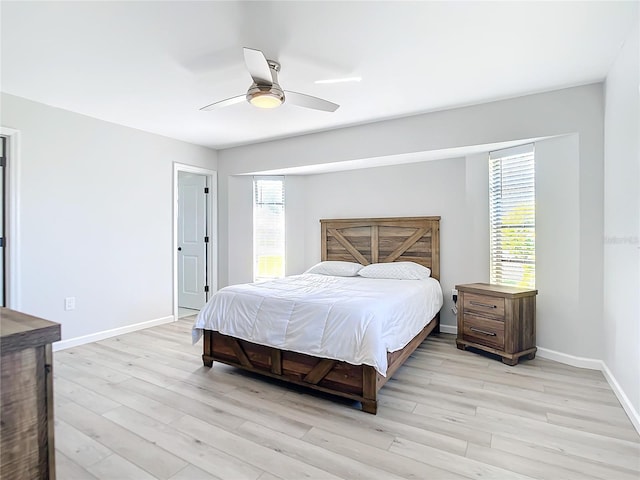 bedroom with ceiling fan and light hardwood / wood-style floors