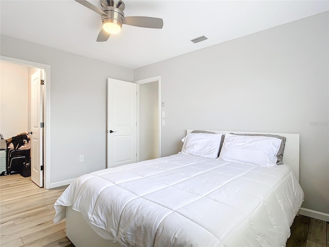 bedroom with ceiling fan and light hardwood / wood-style flooring