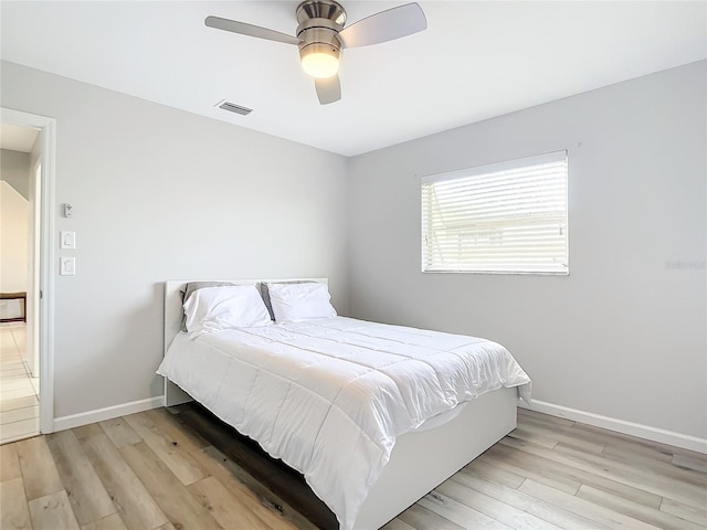 bedroom with light hardwood / wood-style floors and ceiling fan