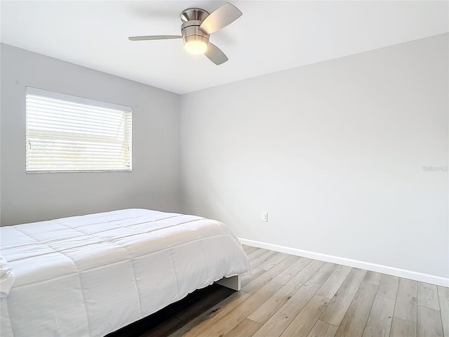 bedroom featuring ceiling fan and light hardwood / wood-style flooring