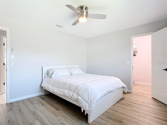 bedroom featuring light hardwood / wood-style floors and ceiling fan